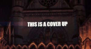 This Is A Cover Up projected on the Royal Courts of Justice