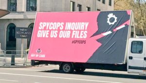 Spycops Inquiry Give Us Our Files poster van at New Scotland Yard