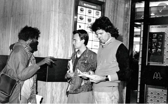 Paul Gravett (centre) & spycop HN10 Bob Lambert 'Bob Robinson' (right) handing out the McLibel leaflet Lambert co-wrote, McDonald's Oxford St, London, 1986