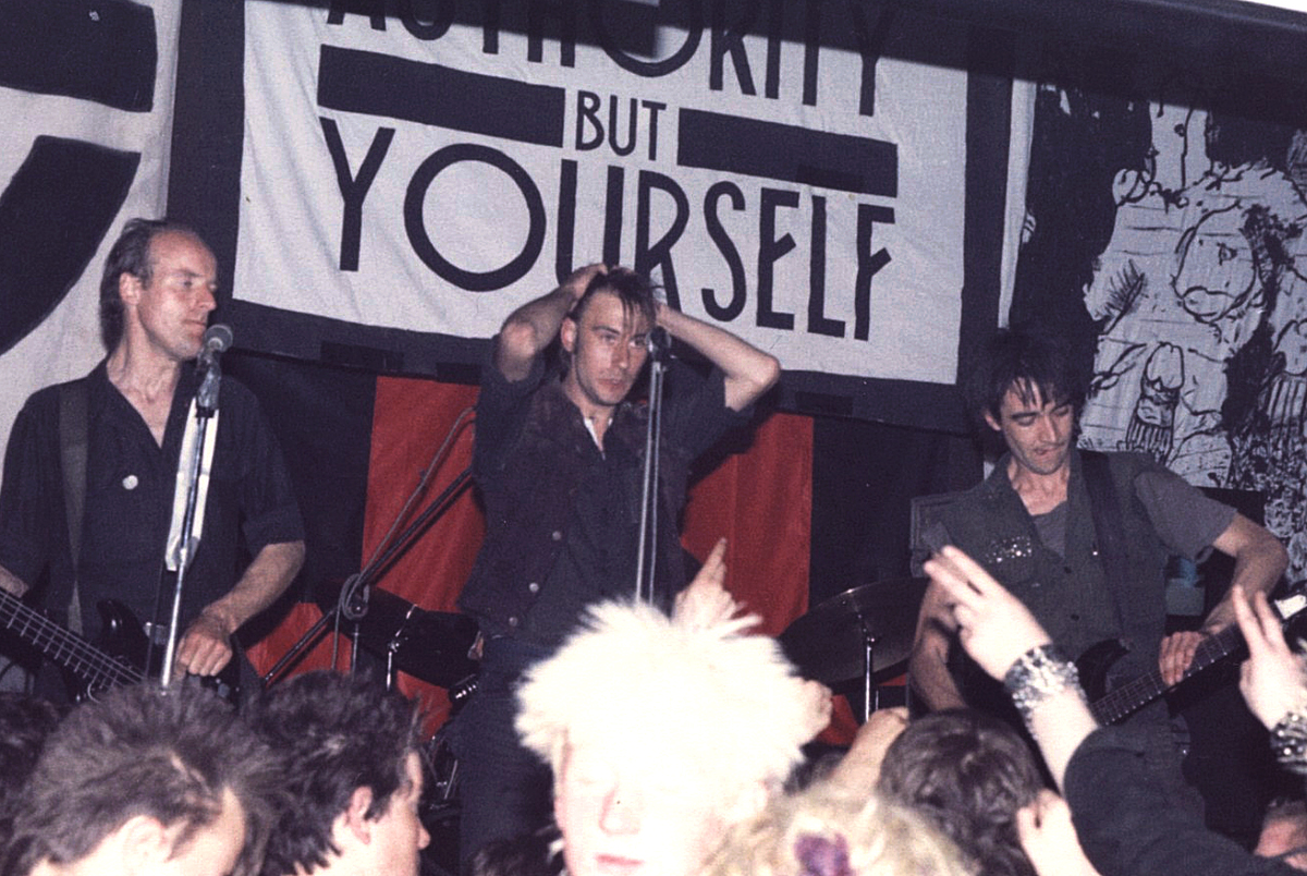 Crass at the Cleatormoor Civic Hall, 3 May 1984.Left to right: Pete Wright (bass), Steve Ignorant (vocals), NA Palmer (guitar). Photo: Trunt