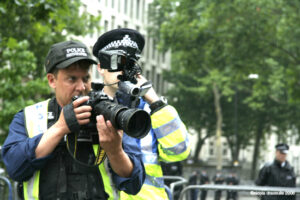 Metrpolitan Police forward Intelligence Team, an intimidating presence at political events in the 1990s and 2000s. (Pic: Nicky Dracoulis, shared under CC BY-SA 2.0 license)